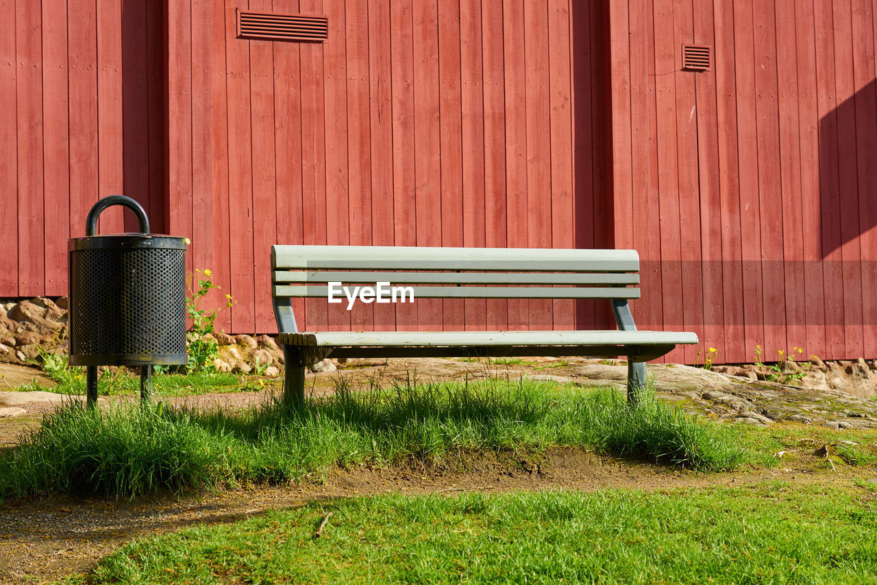 Painted green metal bench in the sun