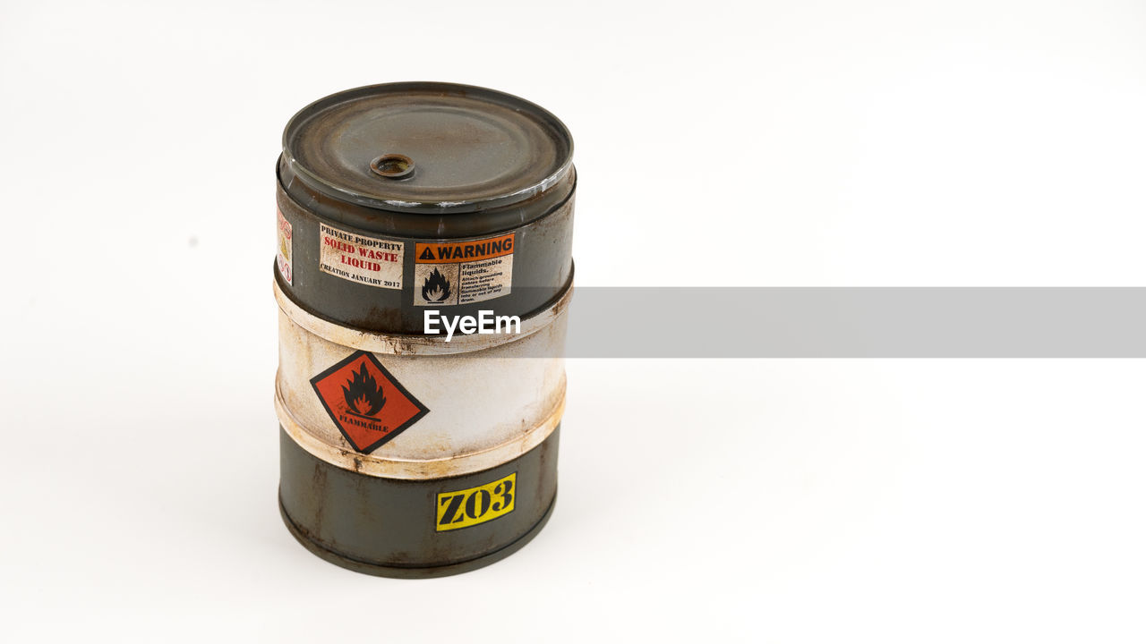 Close-up of old container against white background