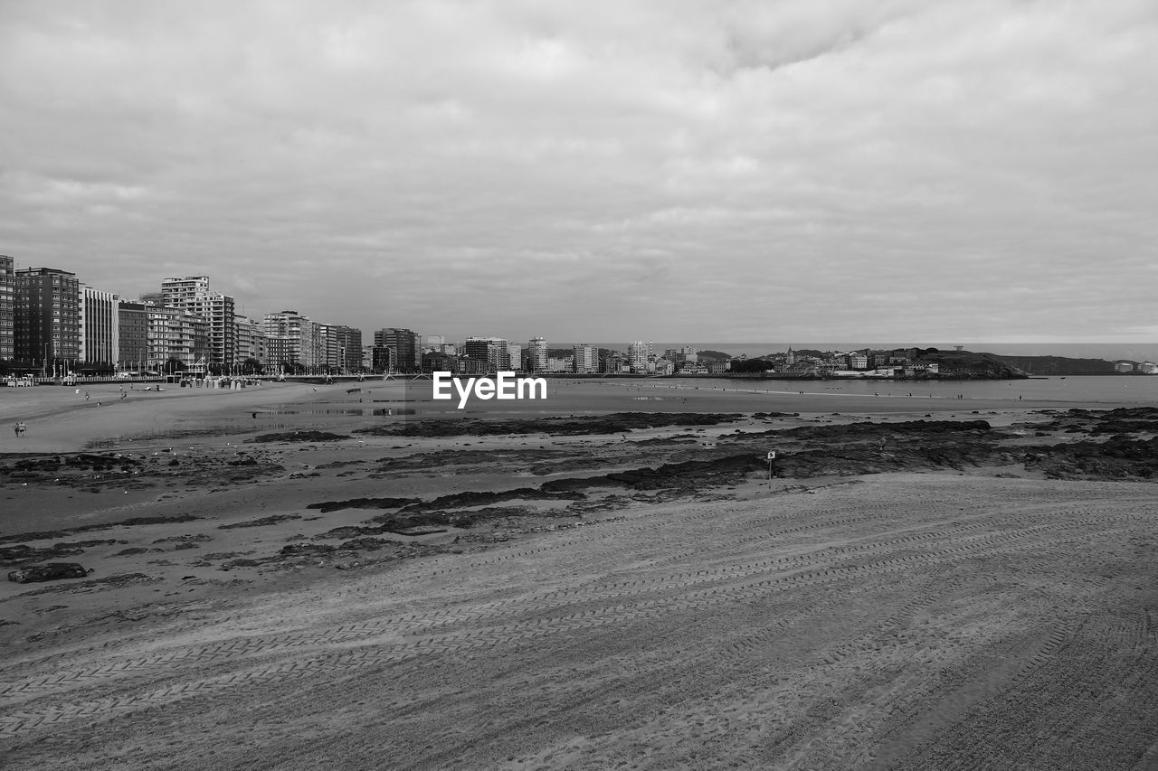 View of beach with city in background
