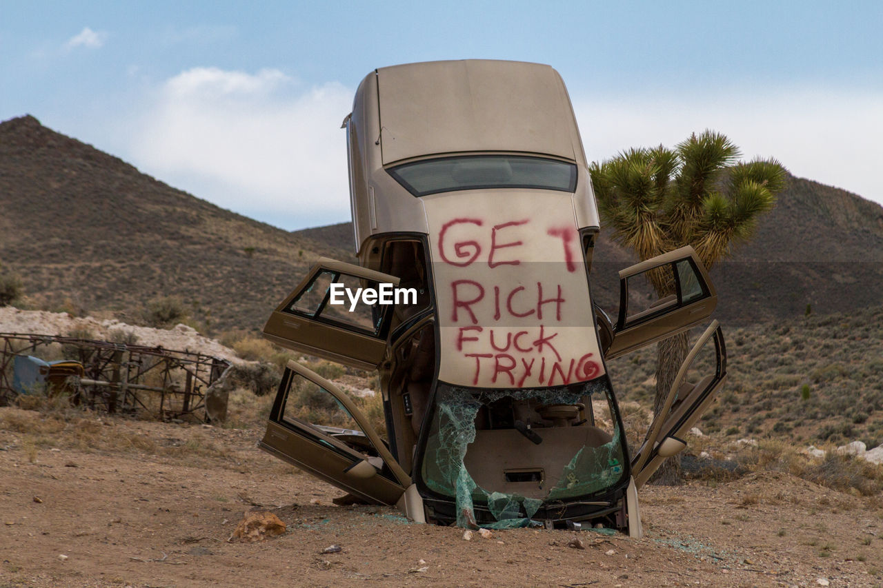 Abandoned vehicle on landscape