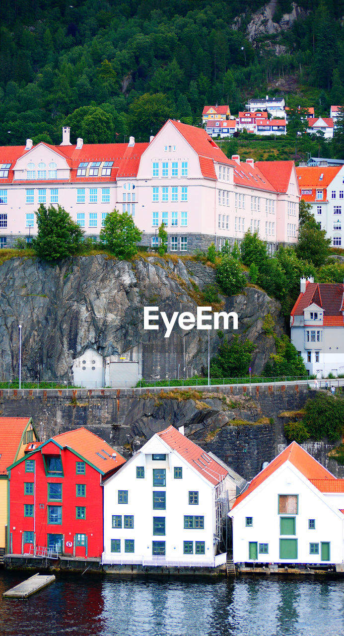 Houses by river and buildings in town