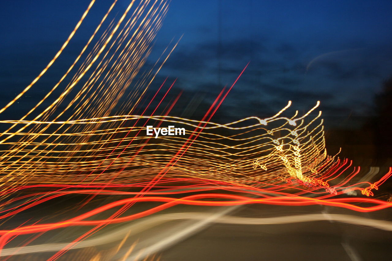 Close-up of light trails against sky at night