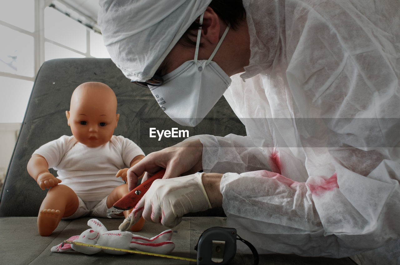 HIGH ANGLE VIEW OF BABY SITTING IN TOY