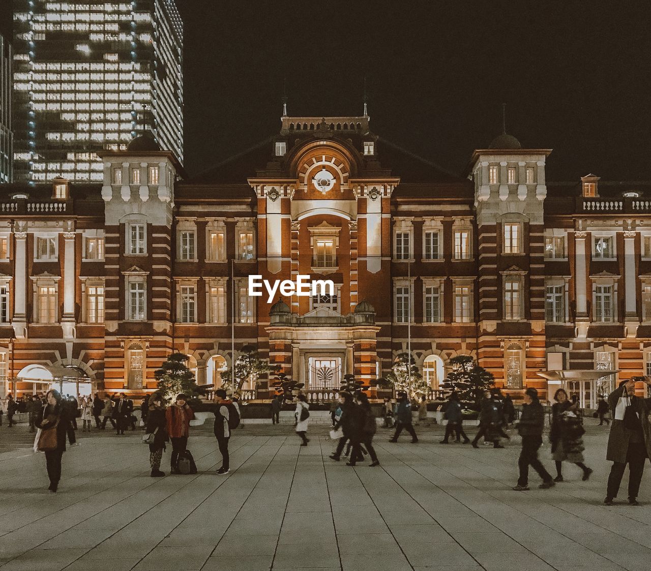 People on street against tokyo station at night