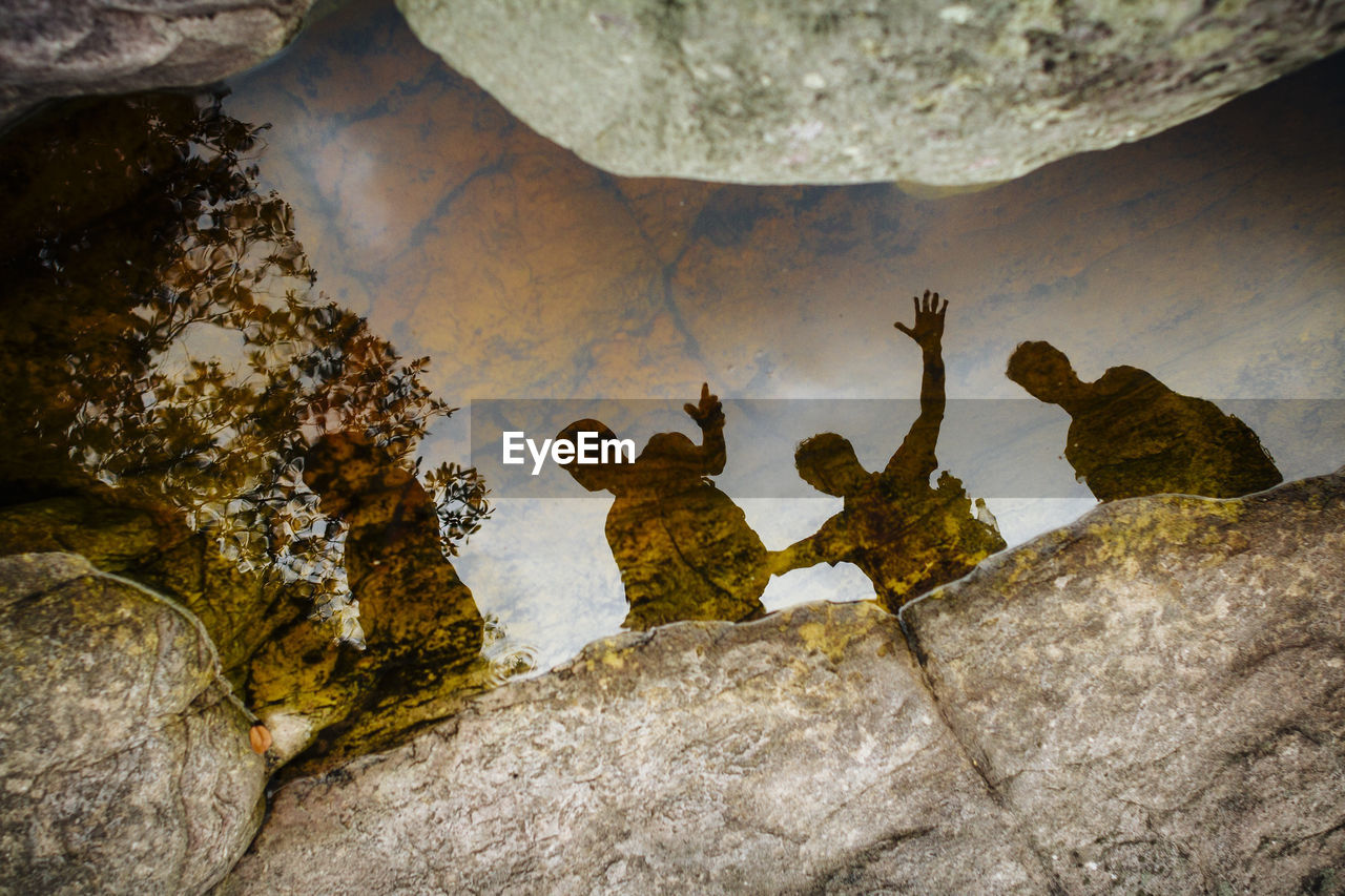 HIGH ANGLE VIEW OF PEOPLE ON ROCK FORMATION