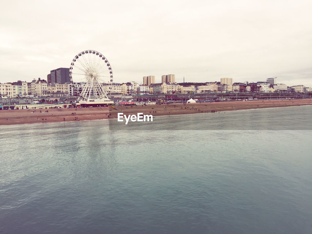 Aerial view of brighton pier on beach against sky