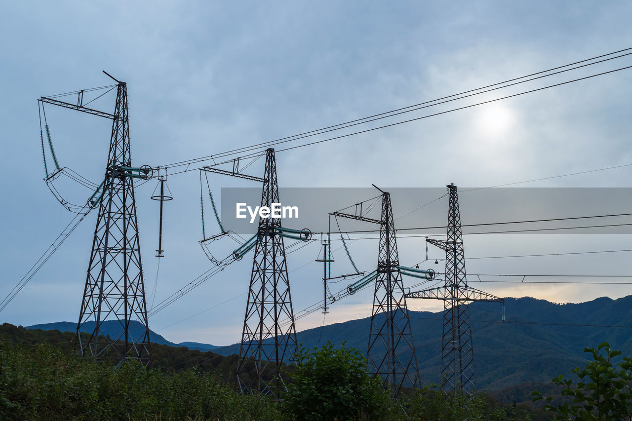 Low angle view of electricity pylon against sky