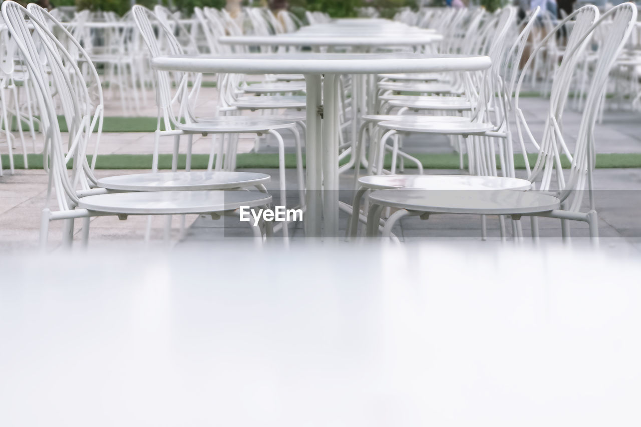 EMPTY CHAIRS AND TABLES IN RESTAURANT