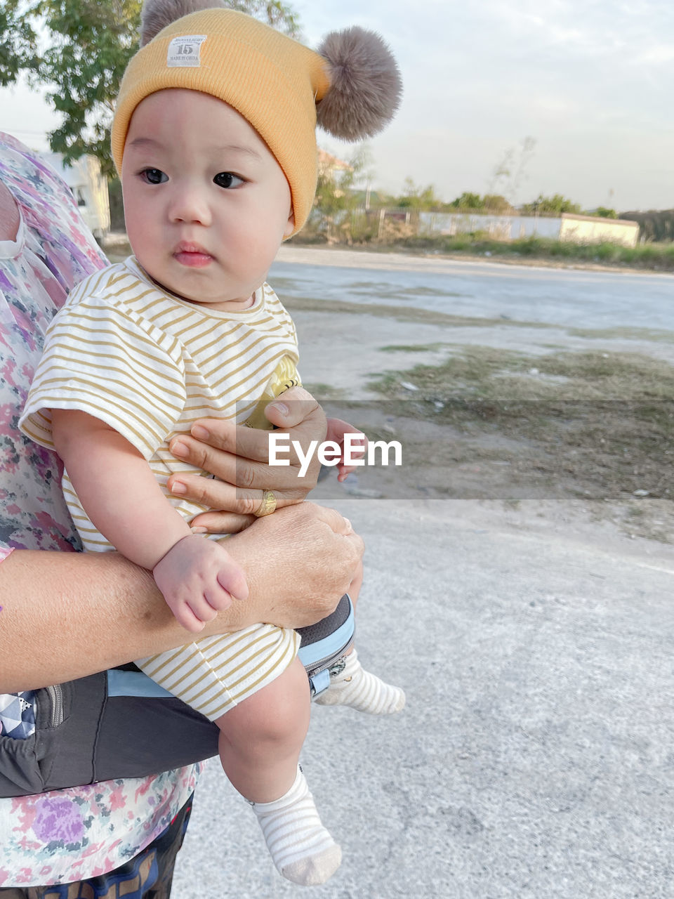 FULL LENGTH OF CUTE BABY GIRL SITTING ON WATER