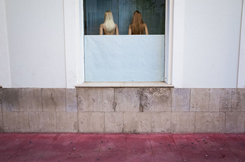 REAR VIEW OF WOMAN STANDING ON FLOOR