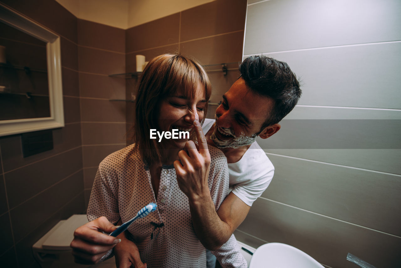 Couple having fun in bathroom at home