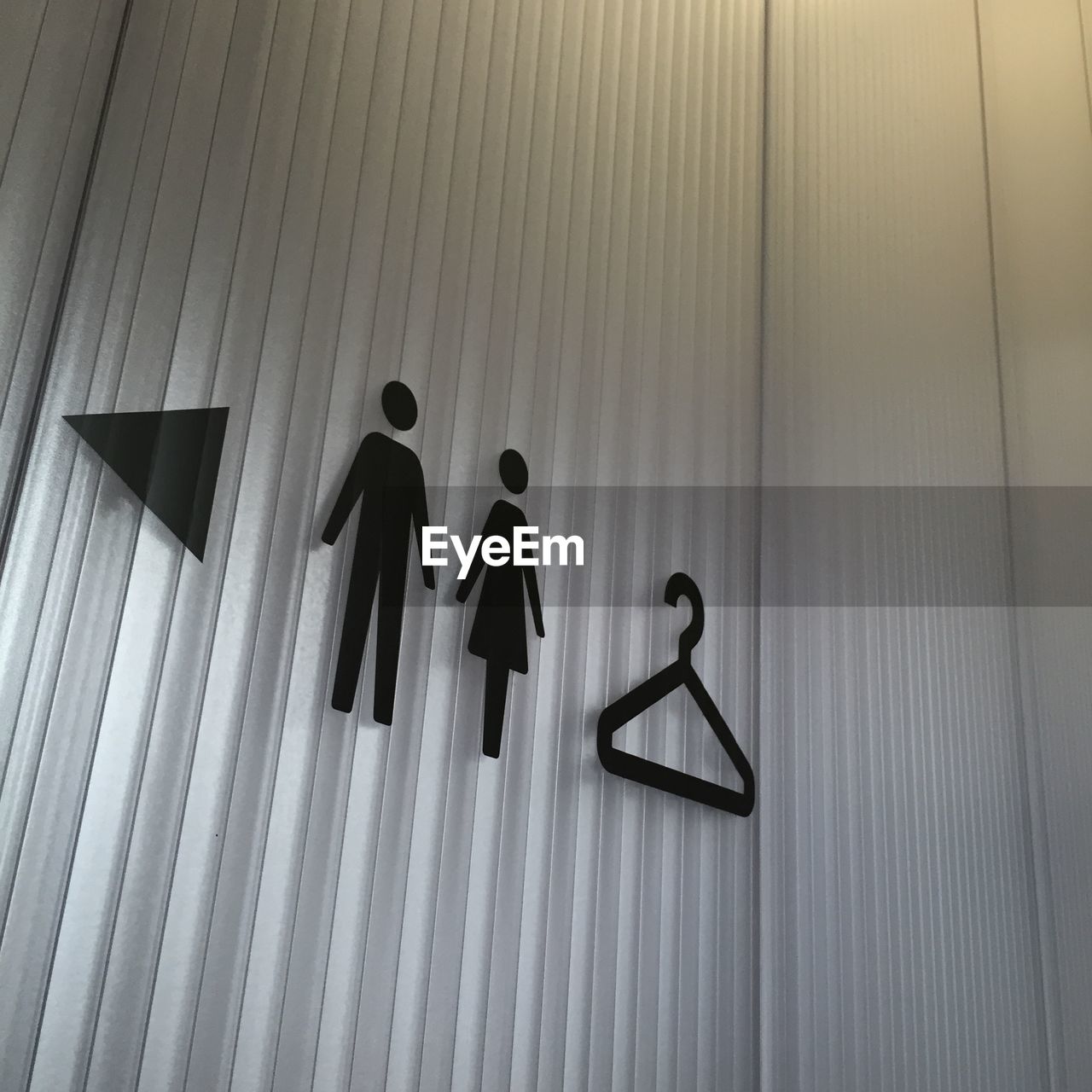 Close-up of restroom signs on wall