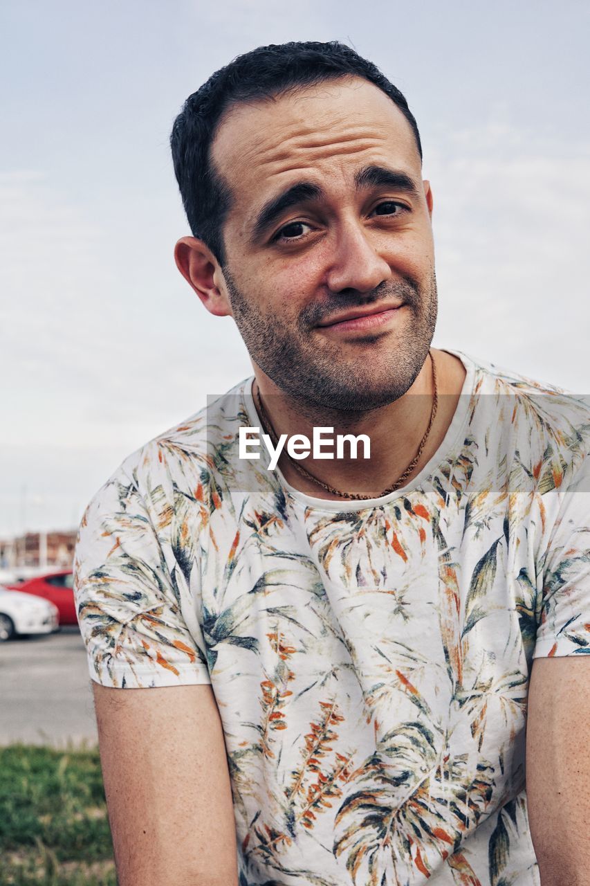  portrait of young man smiling against sky