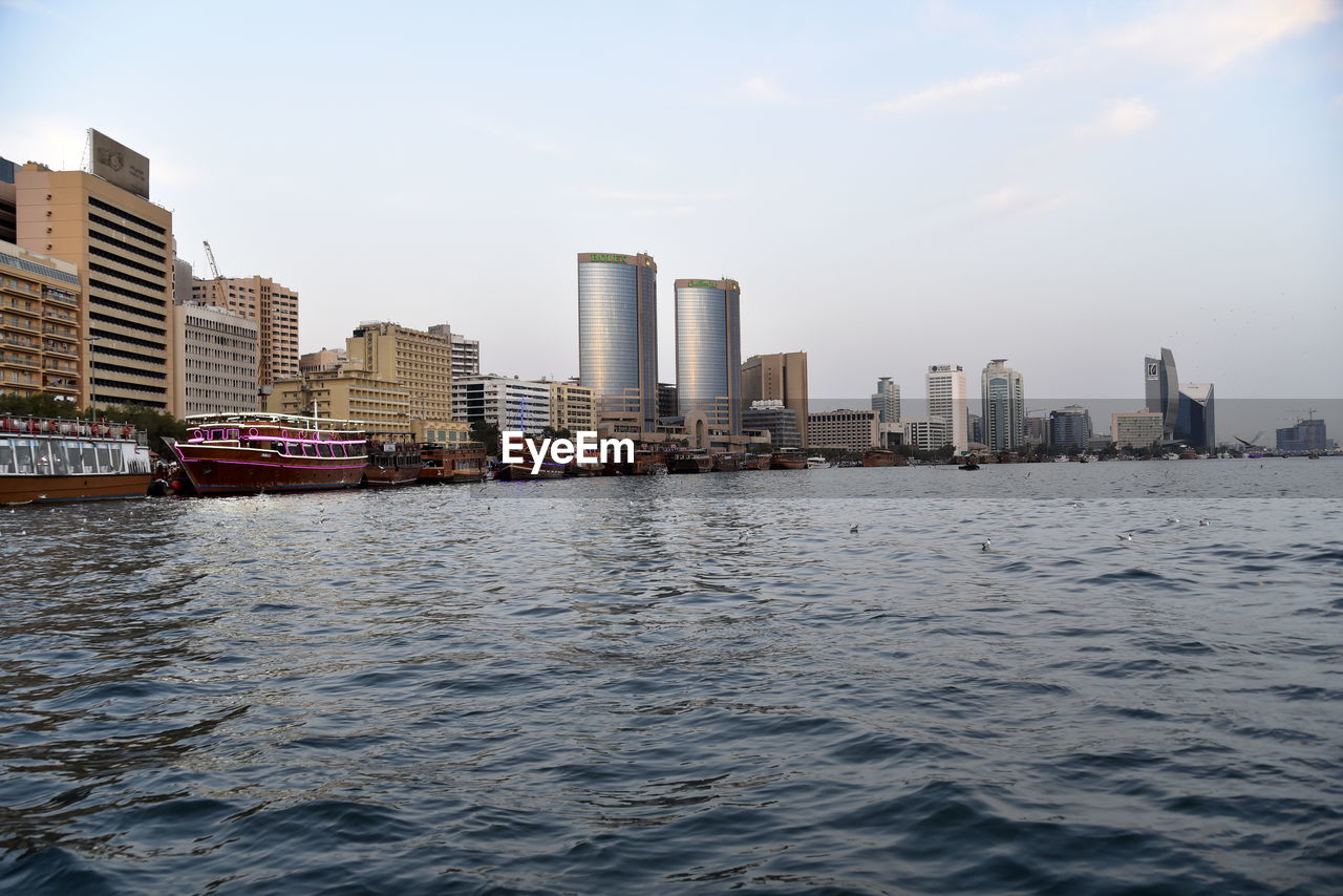 Dubai skyline from dubai creek harbour and dubai canal to downtown and business bay, uae