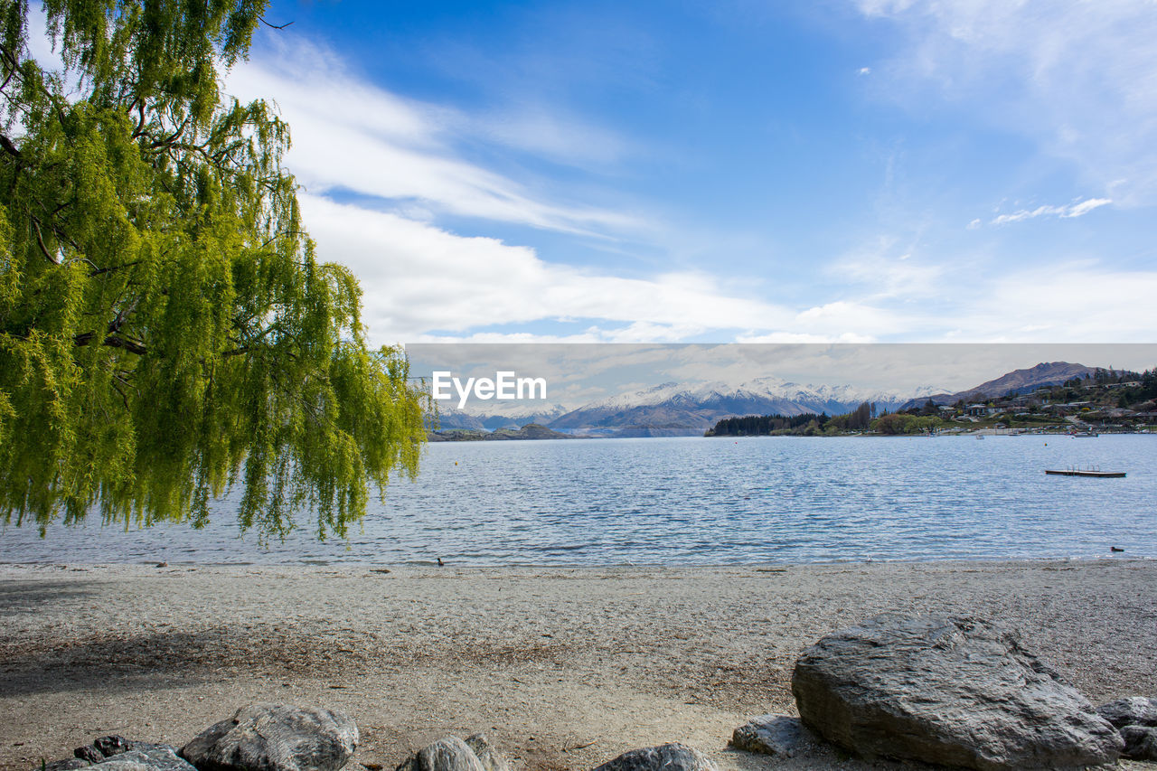 Lake wanaka with snow capped mountains in background.