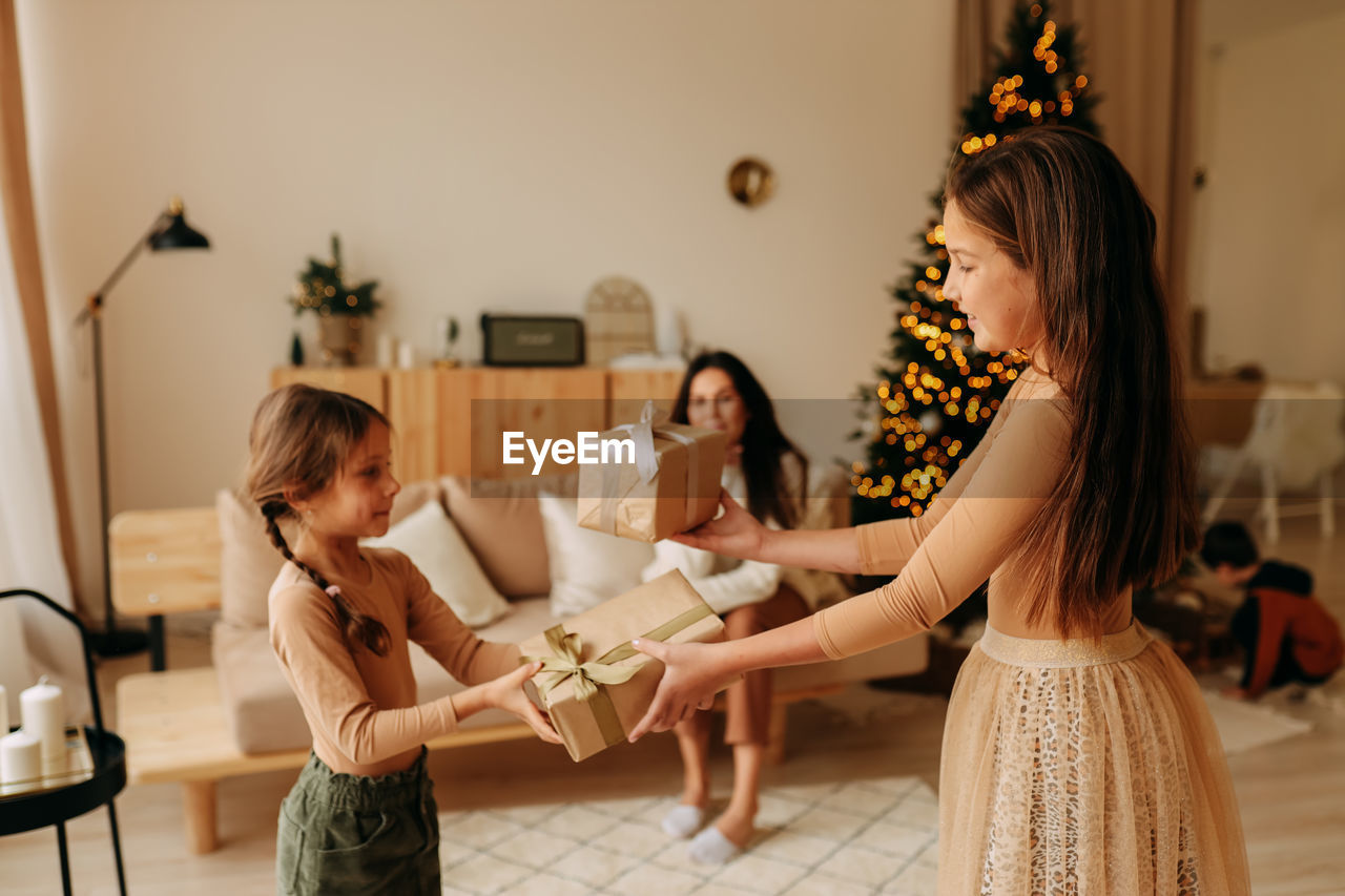 Family lifestyle. mom and kids are preparing for christmas holidays in a decorated house in winter