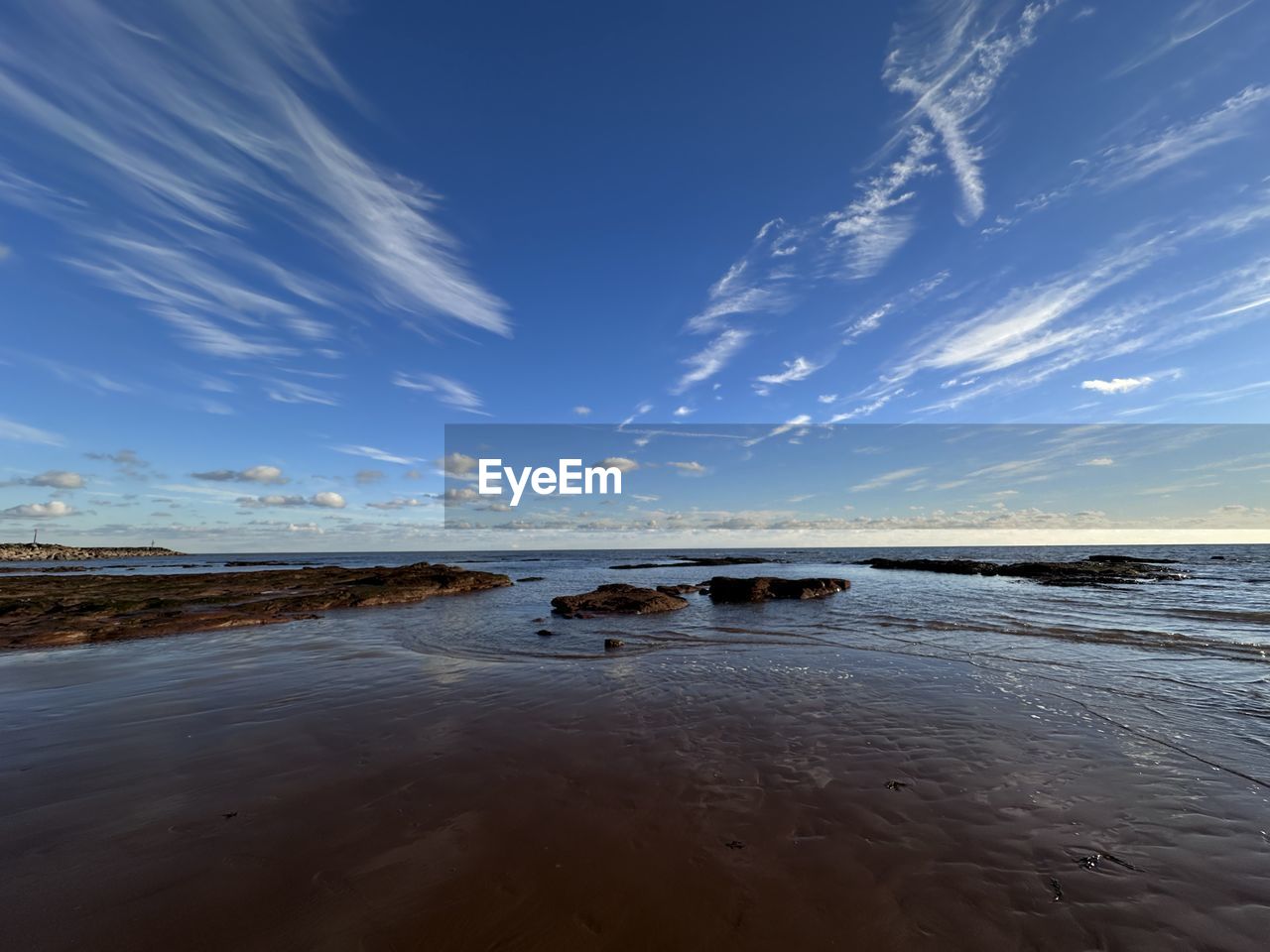 sky, water, horizon, sea, land, wave, ocean, reflection, shore, scenics - nature, sunlight, nature, cloud, beach, body of water, beauty in nature, dusk, morning, coast, blue, tranquility, sunrise, environment, wind wave, sand, tranquil scene, landscape, no people, travel destinations, horizon over water, outdoors, travel, seascape, motion, coastline, day, non-urban scene