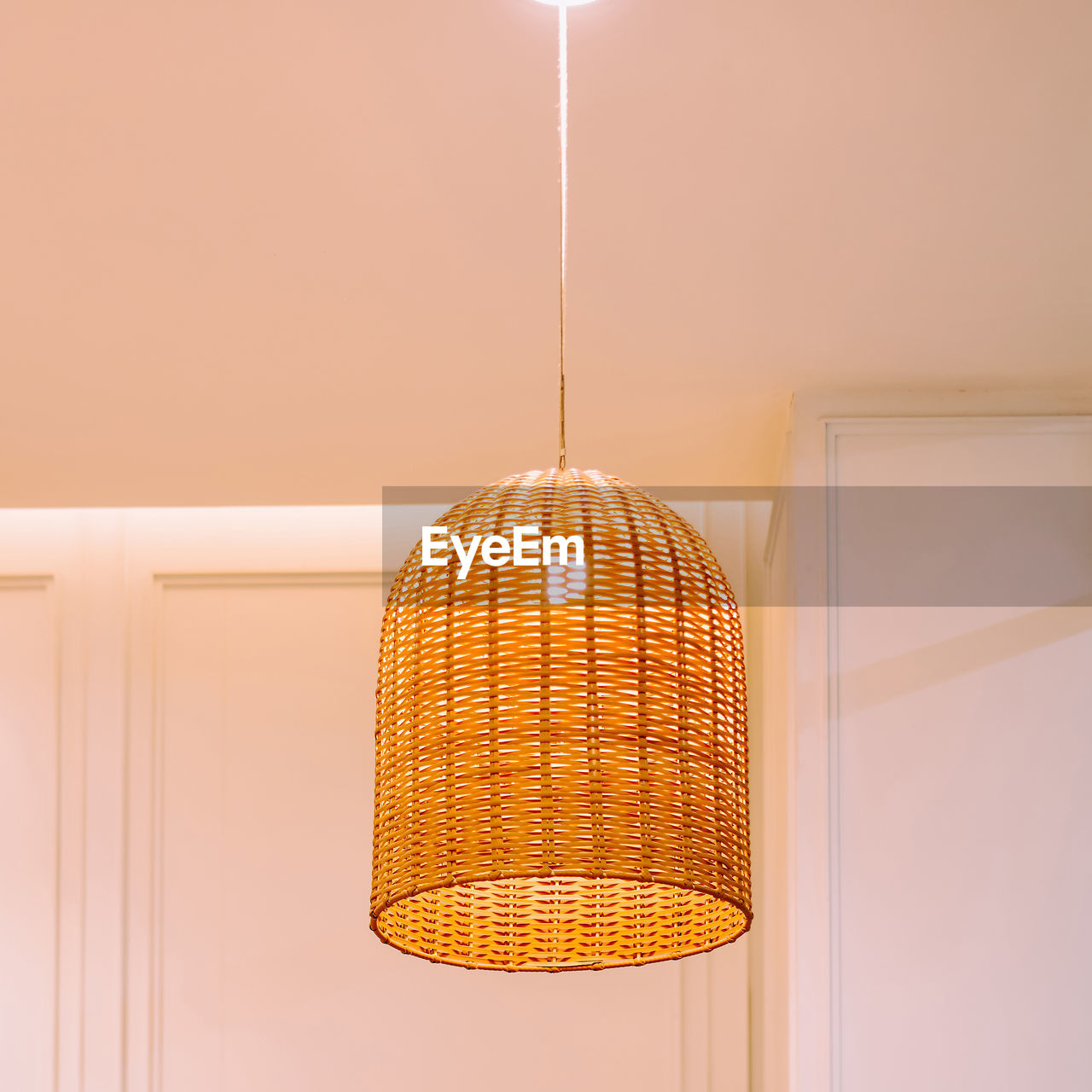 LOW ANGLE VIEW OF ILLUMINATED PENDANT LIGHTS HANGING ON CEILING