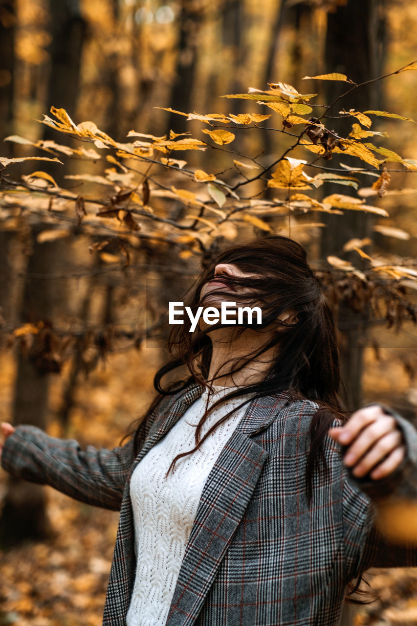 Autumn anxiety, mental health. happy brunette woman enjoy life in autumn forest