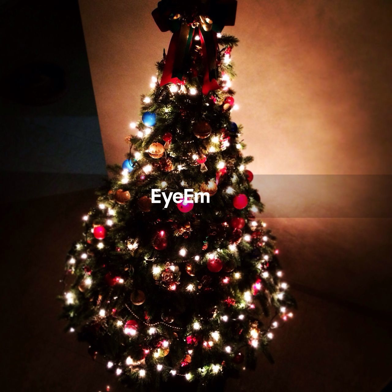Illuminated decorated christmas tree at home