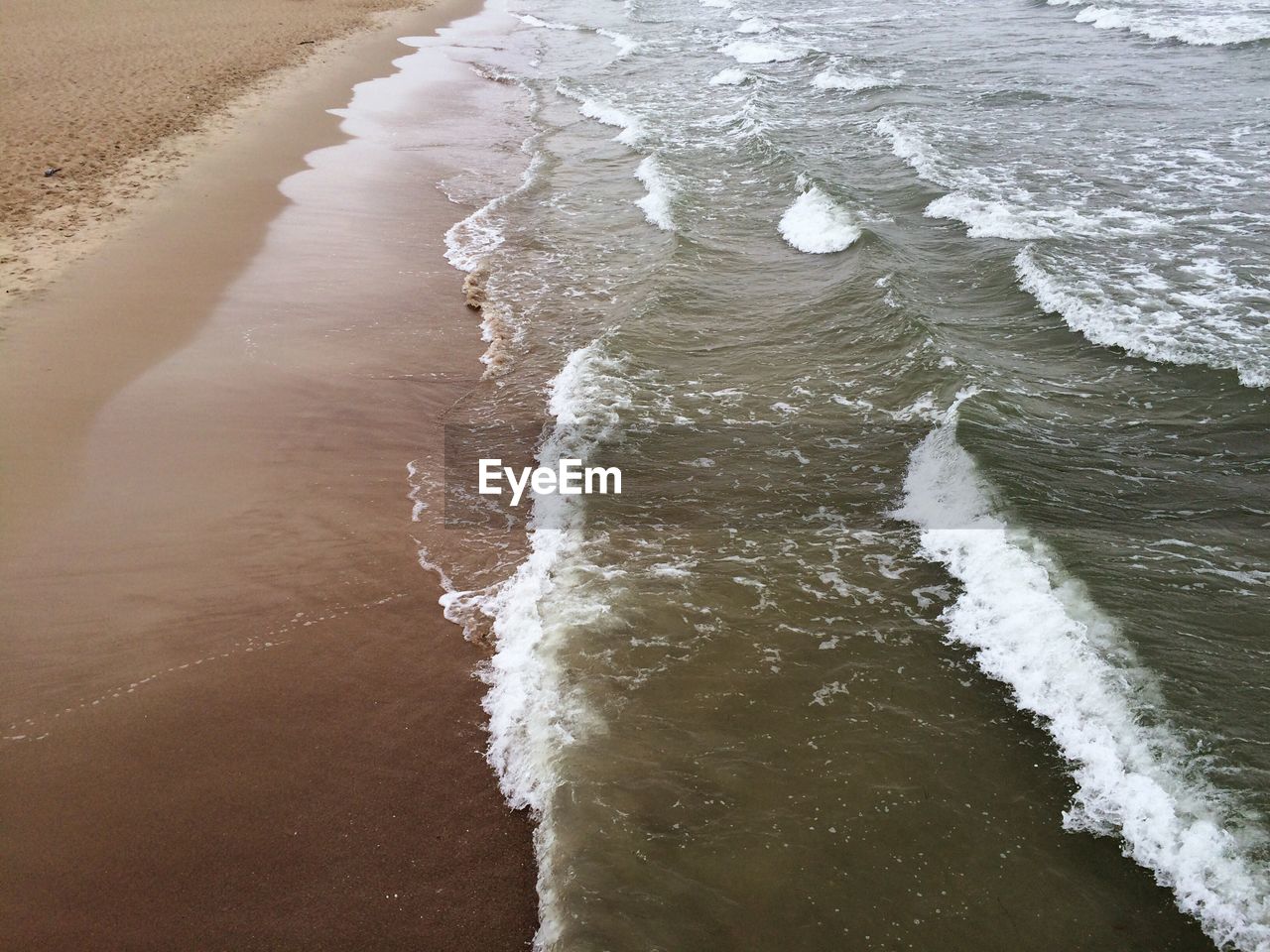 High angle view of waves on beach