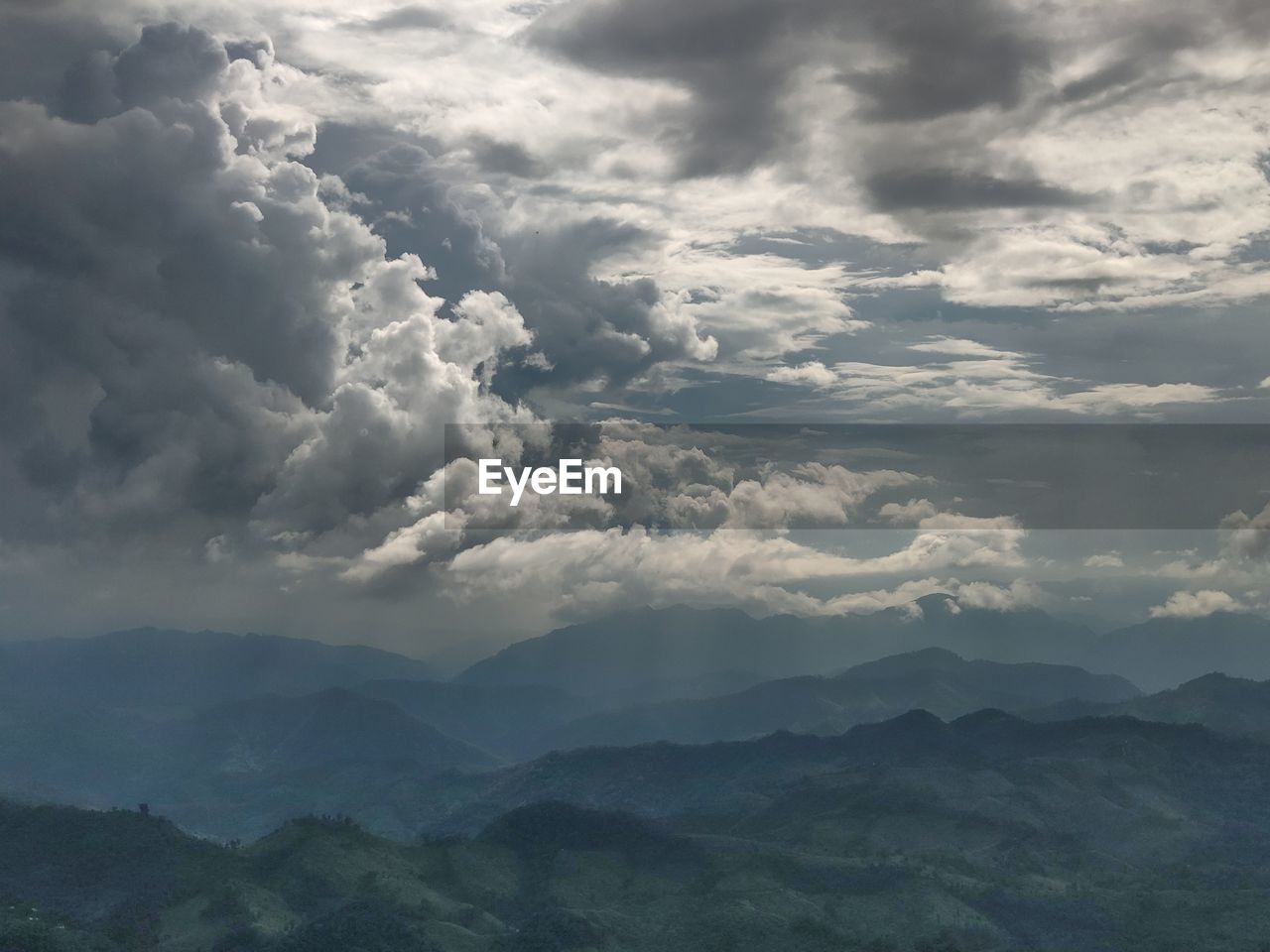 SCENIC VIEW OF CLOUDS OVER MOUNTAINS AGAINST SKY