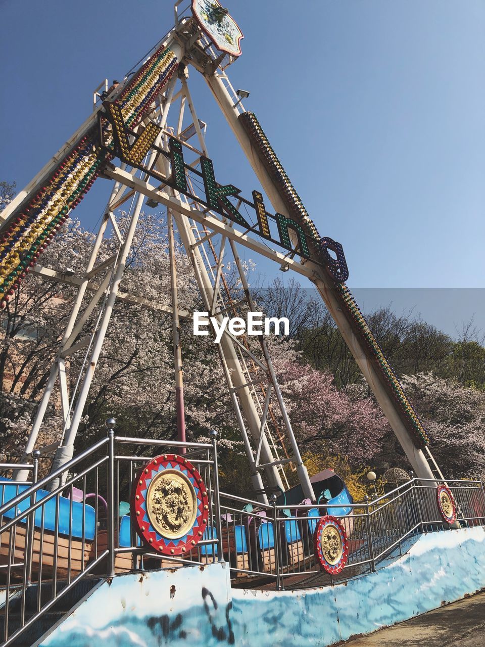 LOW ANGLE VIEW OF CHAIN SWING RIDE AGAINST SKY