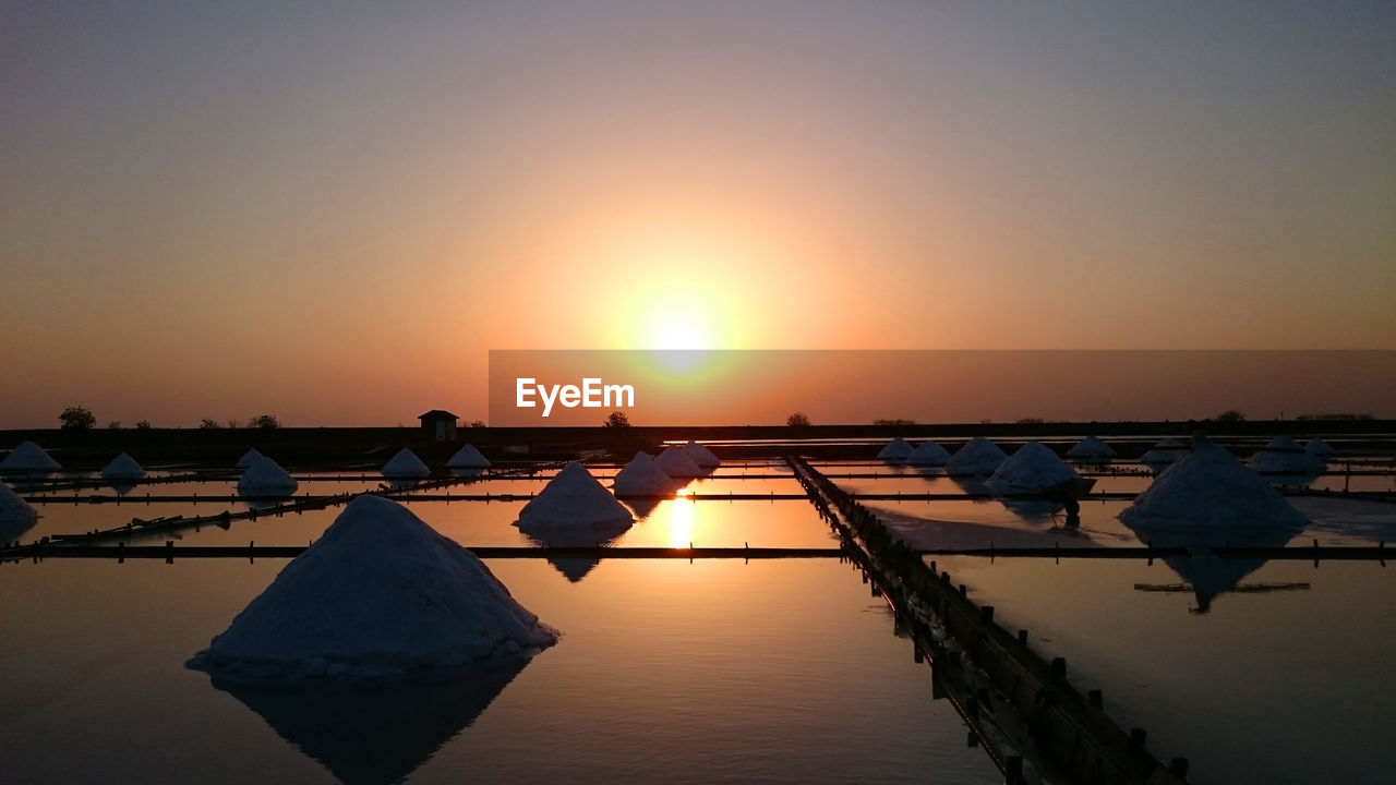 View of salt basin against clear sky during sunset