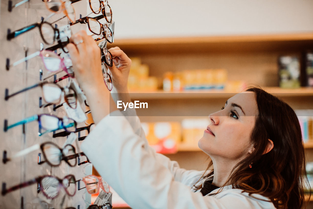 Female optometrist working at store