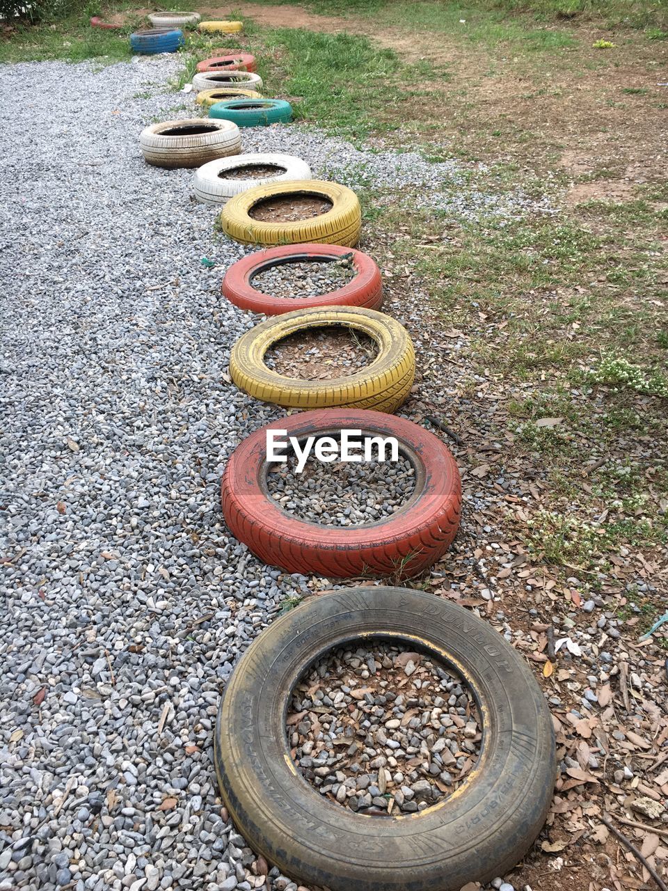 Close-up of multi colored tyres in the grass