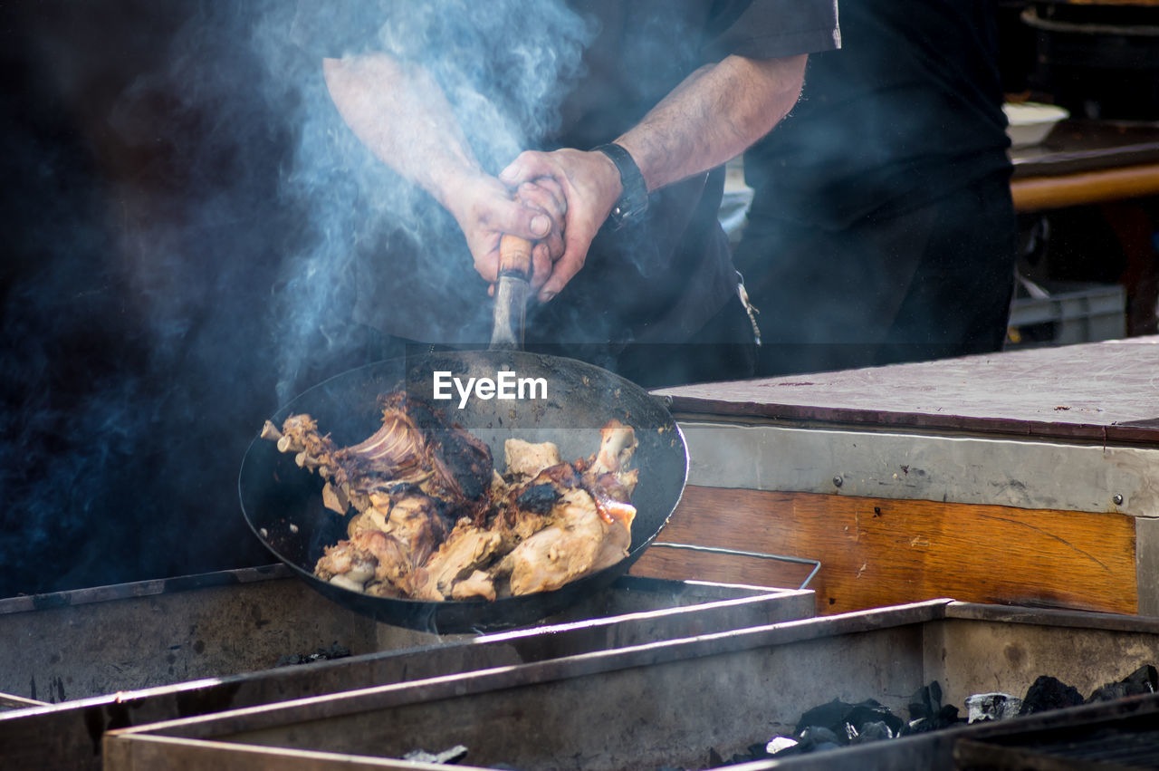 Midsection of man preparing food