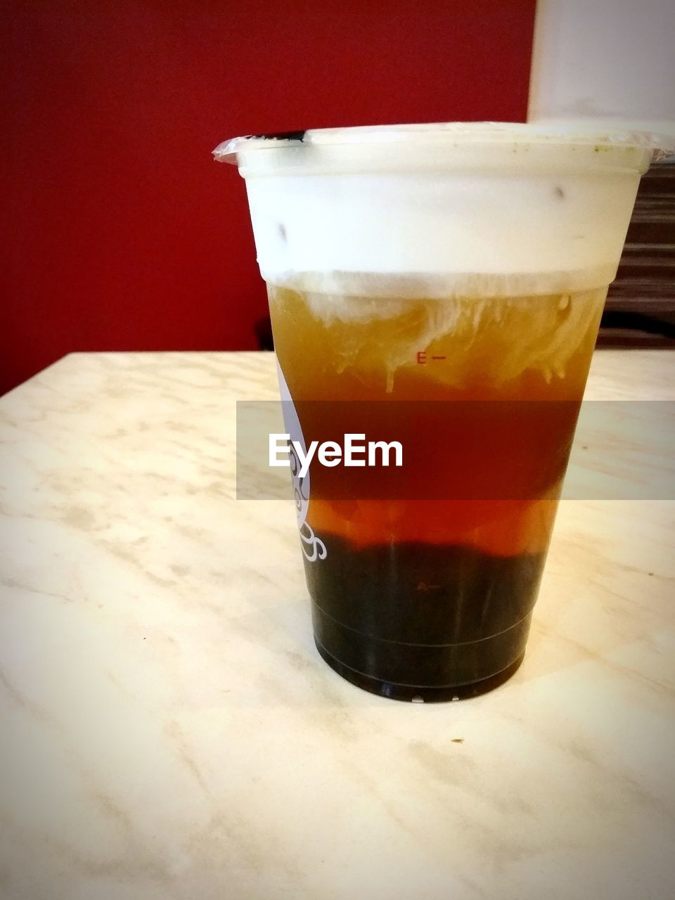 CLOSE-UP OF COFFEE WITH GLASS ON TABLE