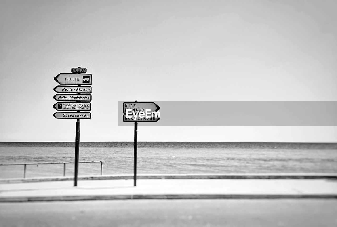 Road signs against calm sea