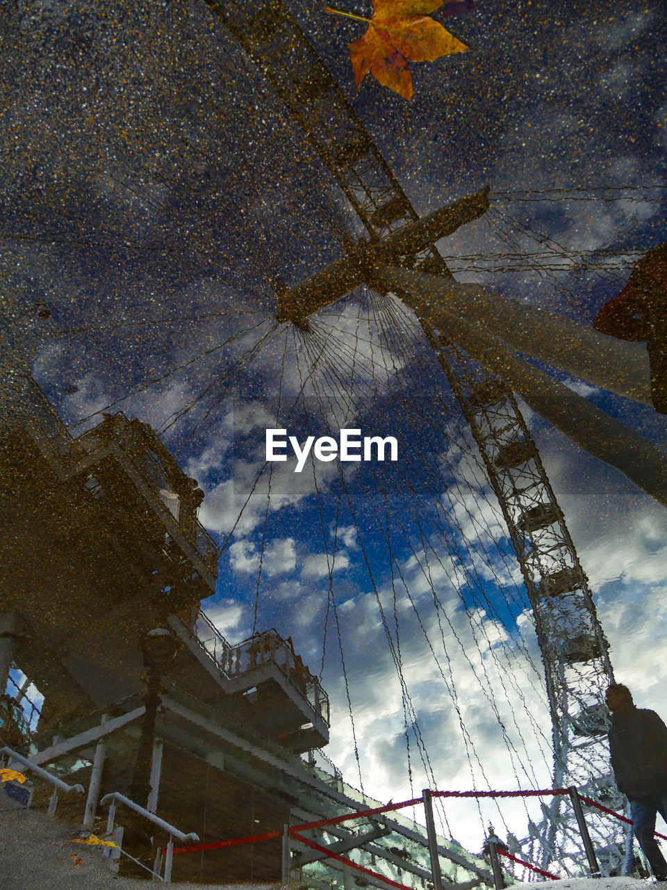 LOW ANGLE VIEW OF BUILDING AGAINST CLOUDY SKY