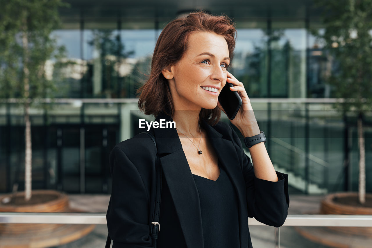 side view of young woman talking on phone