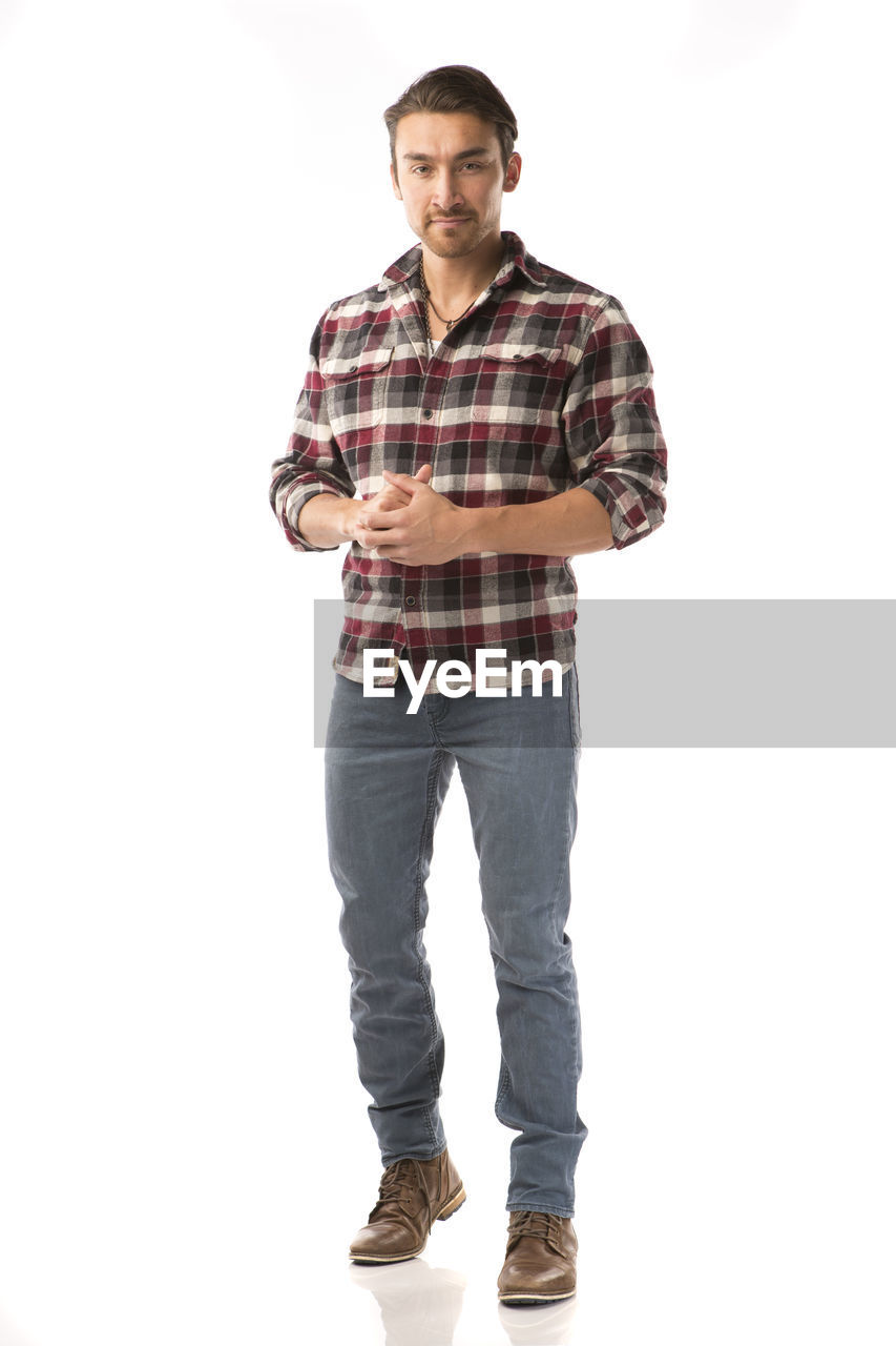 Portrait of male model standing against white background