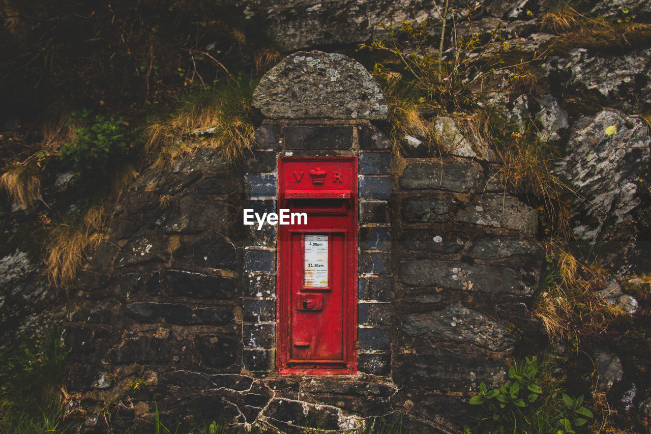 Post office box against wall