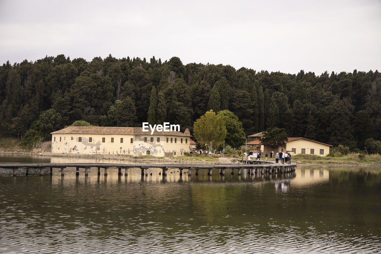 Scenic view of lake by building against sky