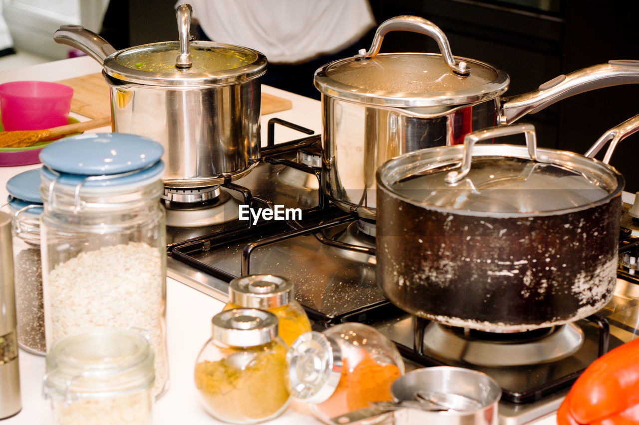 High angle view of cooking pans on gas in kitchen