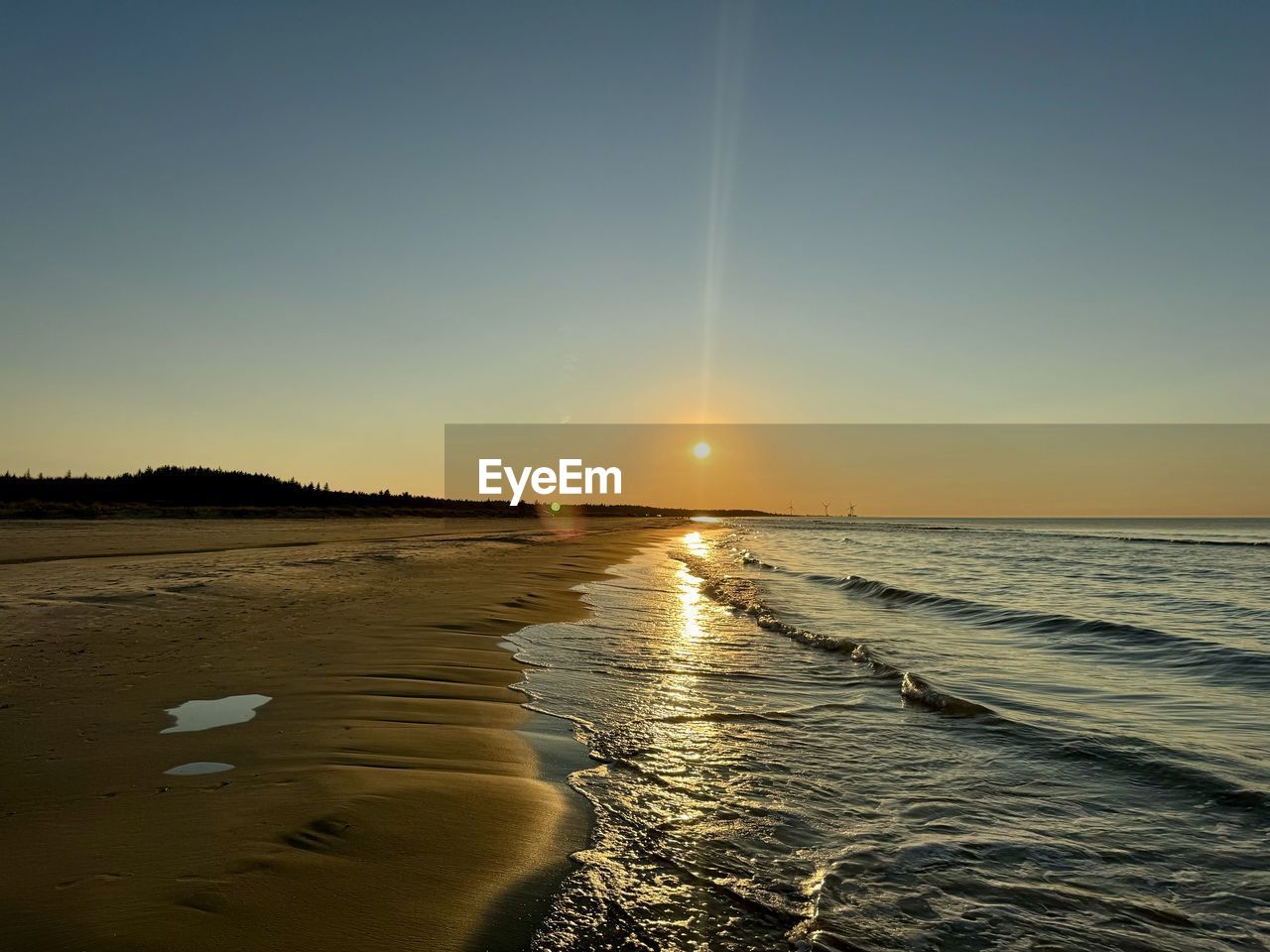sky, water, sea, horizon, beauty in nature, sunset, land, scenics - nature, wave, ocean, nature, sunlight, beach, shore, tranquility, sun, tranquil scene, coast, horizon over water, body of water, reflection, dawn, wind wave, motion, idyllic, clear sky, no people, environment, outdoors, sand, evening, seascape, travel, landscape, travel destinations, non-urban scene, blue, light