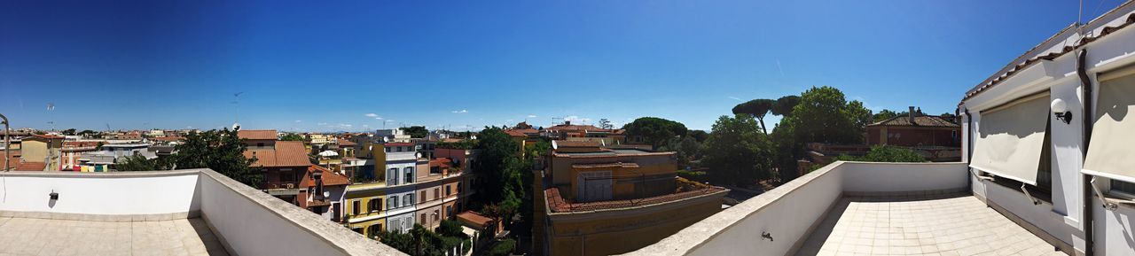 PANORAMIC VIEW OF TOWN AGAINST CLEAR BLUE SKY