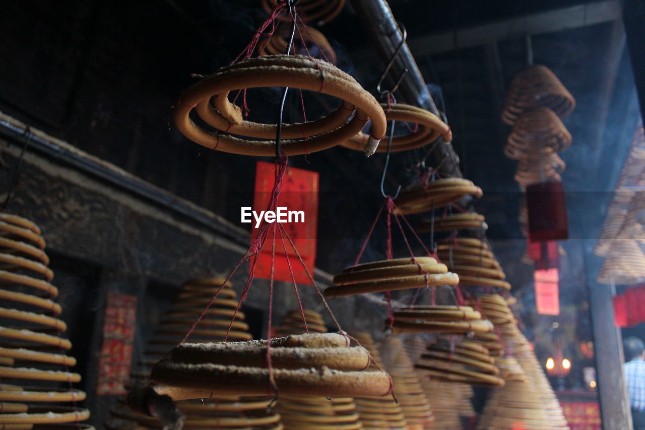 LOW ANGLE VIEW OF DECORATIONS HANGING ON BUILDING