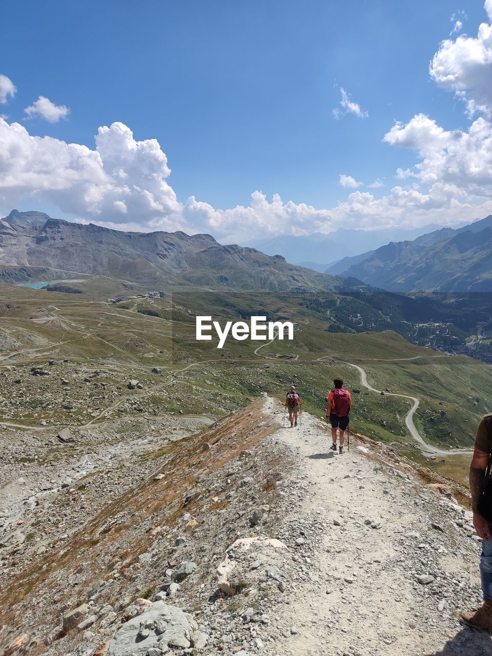 adventure, nature, extreme sports, sports, cloud, sky, leisure activity, day, mountain, mountain range, parachuting, outdoors, beauty in nature, scenics - nature, rock, men, lifestyles, cliff, land, terrain, water, activity, risk, mountaineering, travel, high angle view, motion, one person, transportation, exhilaration, skill, vacation, sign, sunlight, holiday, environment, trip, ridge, blue, climbing, recreation, warning sign, communication, air sports, joy, courage, adult