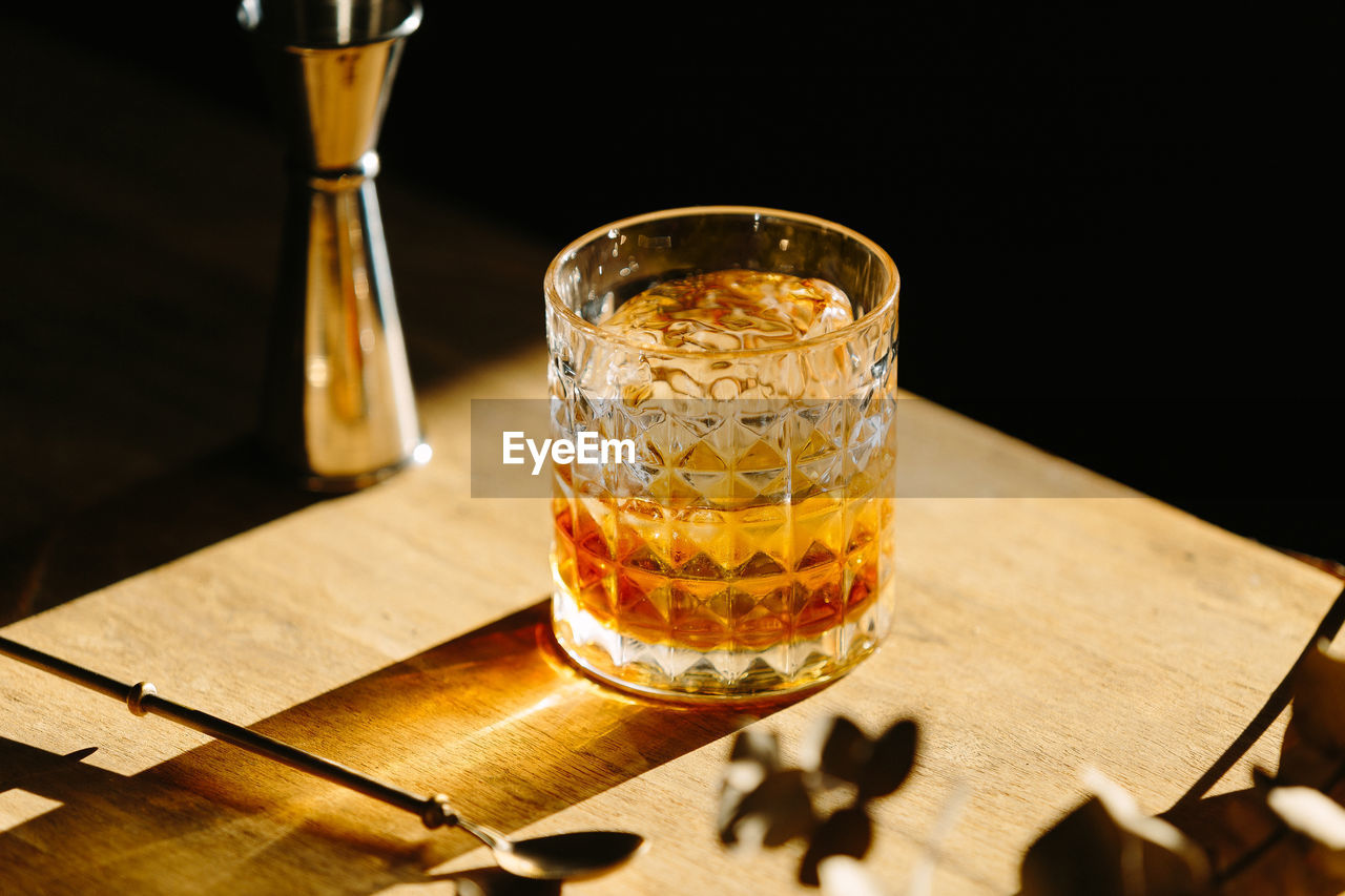 Close-up of glass with bourbon whiskey on table