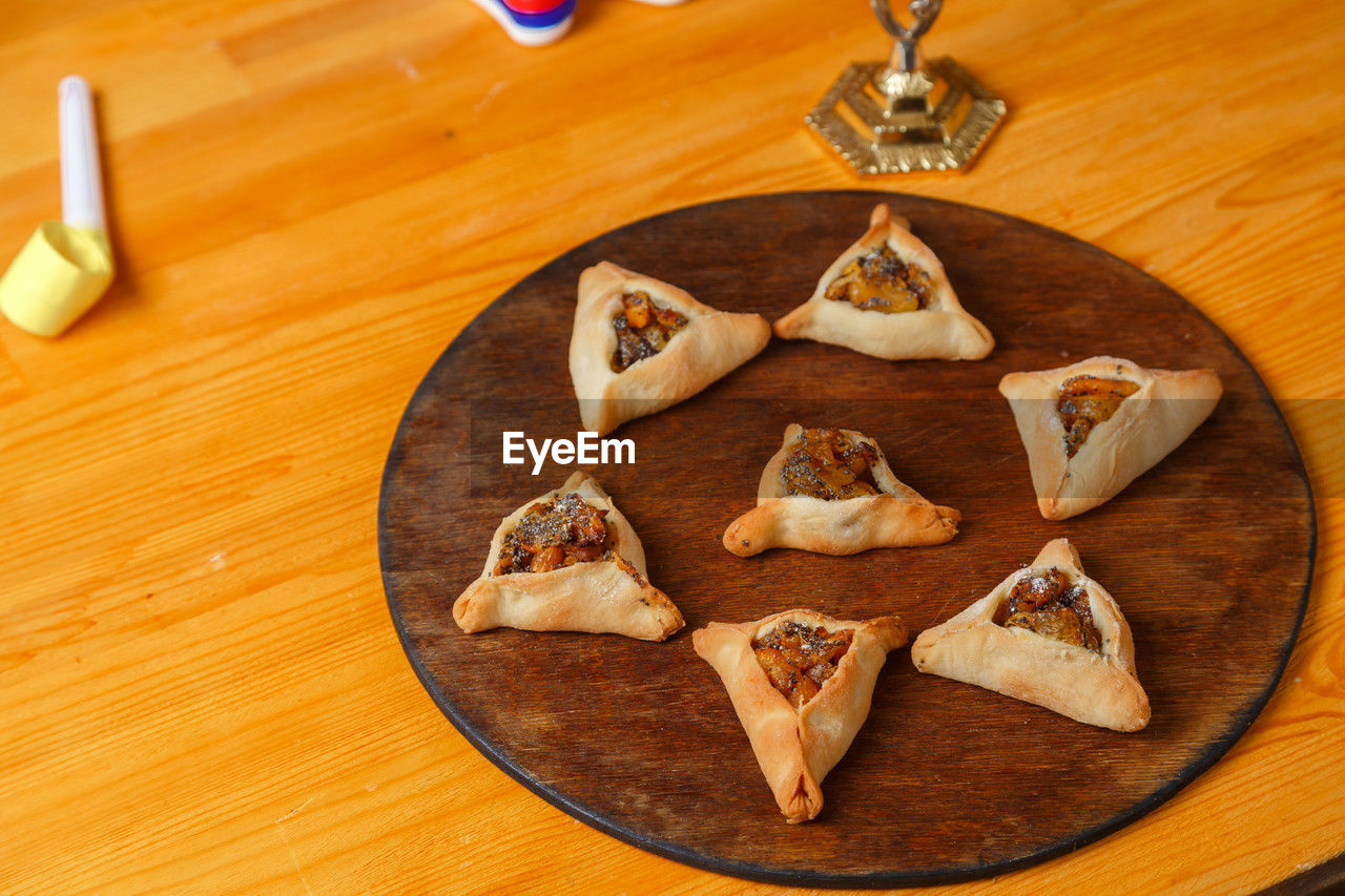 food and drink, food, wood, table, indoors, freshness, high angle view, no people, dish, shape, still life, dessert, star shape, healthy eating, baked, snack, sweet food, wellbeing