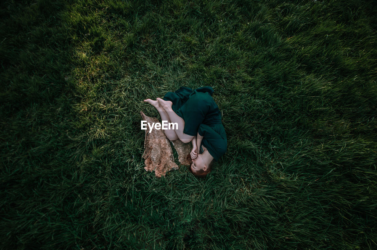 High angle view of woman lying on grass