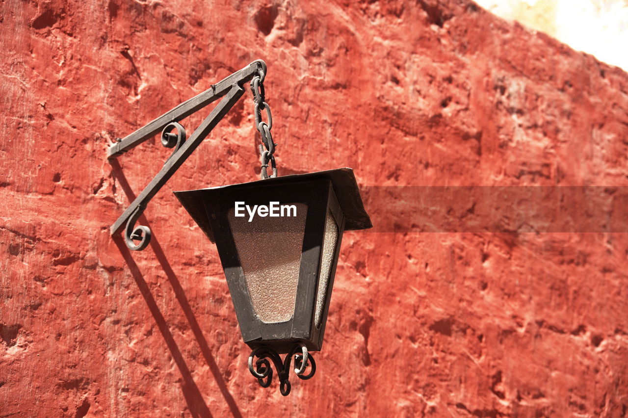 red, no people, day, nature, hanging, wall - building feature, outdoors, metal, sunlight, soil, communication