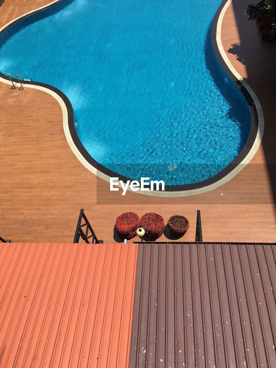 HIGH ANGLE VIEW OF CHOCOLATE ON SWIMMING POOL AGAINST BLUE SKY