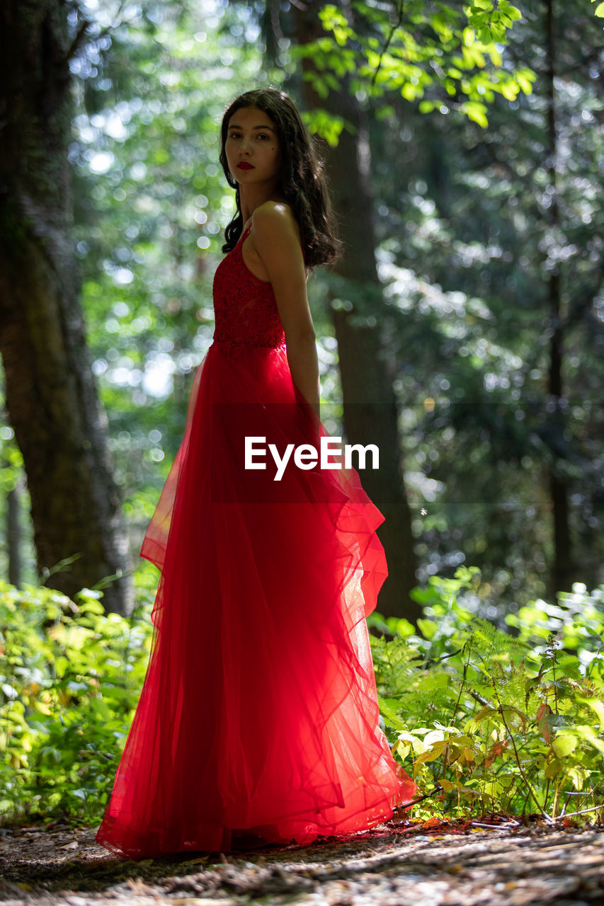 Young woman standing in forest