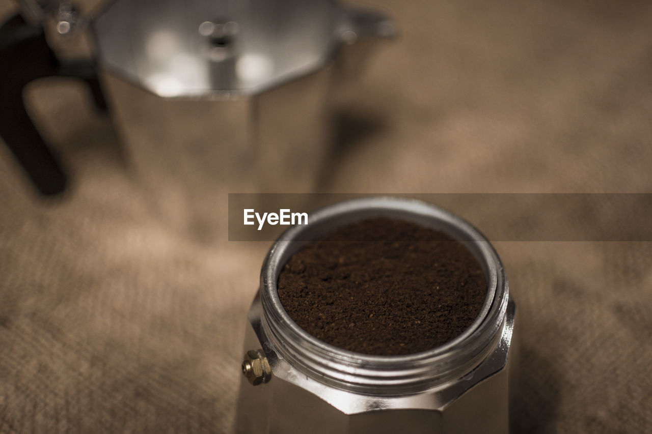 food and drink, human eye, coffee, indoors, food, drink, close-up, ground coffee, metal, freshness, focus on foreground, high angle view, wood, hand, table